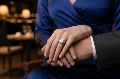 Silver ring with a square baguette-cut center stone on clasped hands