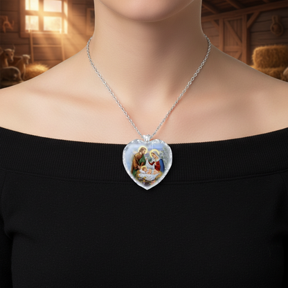 Heart-shaped crystal pendant necklace with religious scene, worn on silver chain