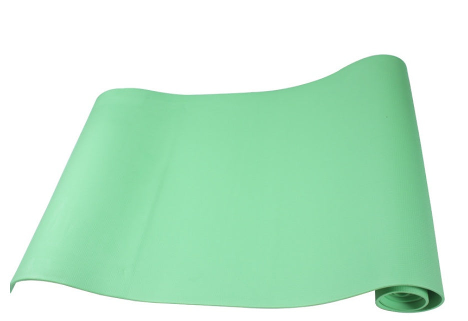 Green fitness yoga mat, rolled and shown in a curved sheet view with open end