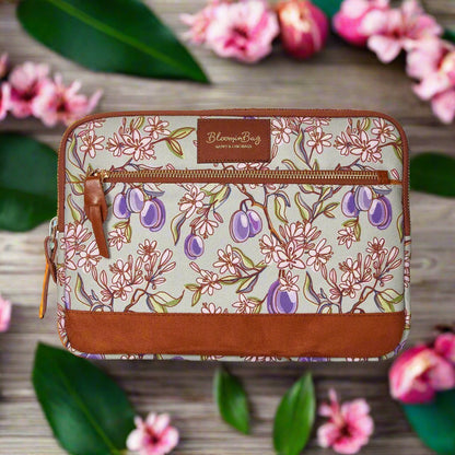 Floral-patterned pouch with brown accents on a white background