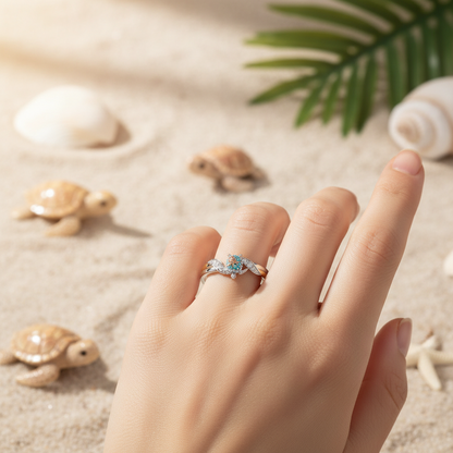Turtle motif ring with blue and clear stones on a silver band