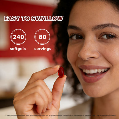 Red softgel capsule held between fingers for easy swallowing supplement.
