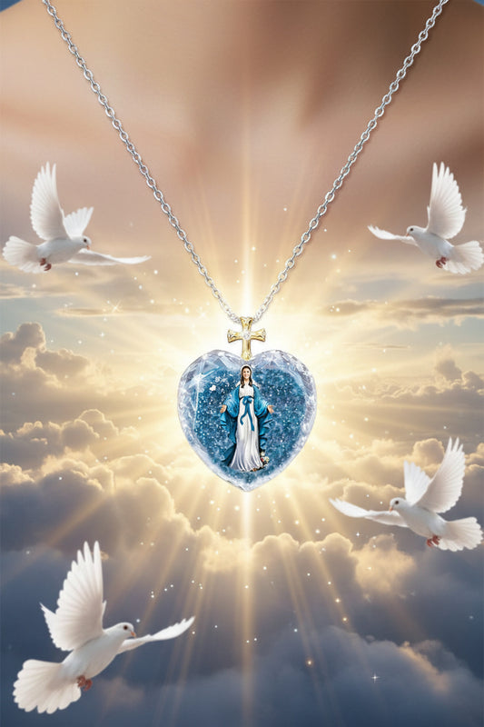 Blue crystal heart pendant with gold cross charm on silver chain, blue-robed figure inside.