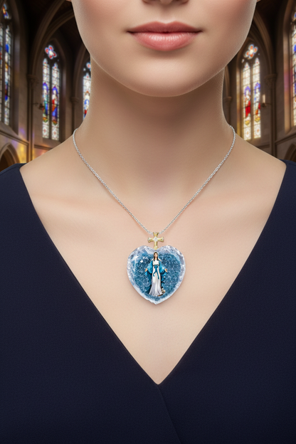 Blue crystal heart pendant necklace with gold cross charm on silver chain, worn at collarbone.
