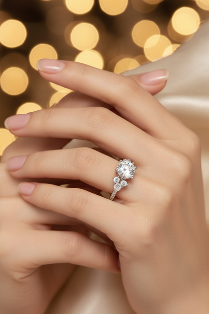 Close-up silver halo moissanite ring with round center stone and two side stones