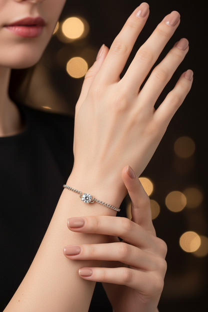 Silver diamond bracelet with round center stone on wrist, chain links visible