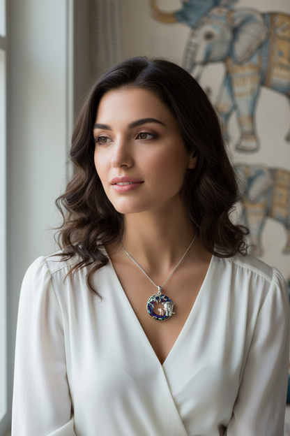 Elephant pendant necklace with blue crystal accents on a silver-tone chain