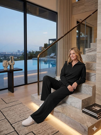 Black two-piece tracksuit with quarter-zip long-sleeve top and wide-leg pants