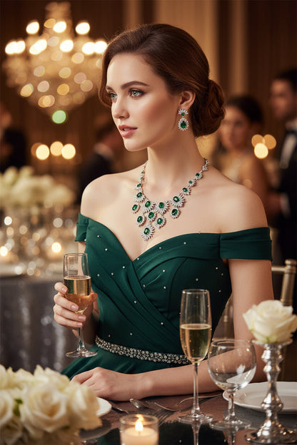 Green rhinestone necklace with matching drop earrings featuring leaflike sparkle