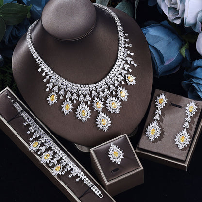 Silver-tone necklace and earring set with yellow center flower motifs and matching bracelet