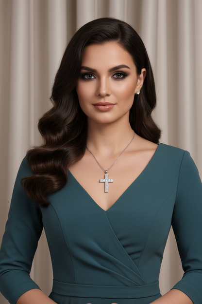 Silver cross pendant necklace with clear-stone accents on a chain at neckline