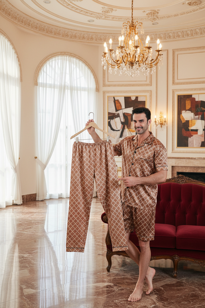 Brown patterned short suit set: model holding matching shorts and short-sleeve shirt