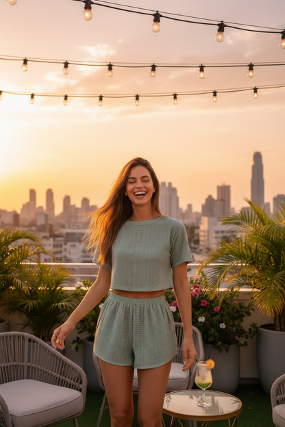 Green hollow-knit crop top and elastic-waist shorts set, front view