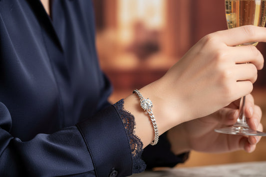 Silver diamond bracelet on wrist with round center stone and link chain