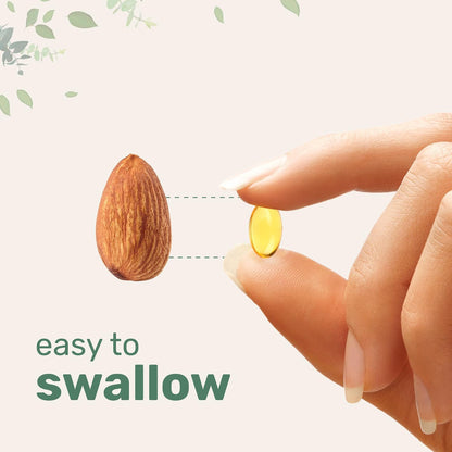 Yellow softgel held in fingertips for oregano oil and black seed oil supplement