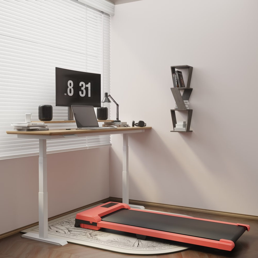 Red folding treadmill with black running deck under a standing desk