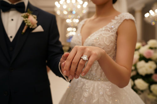 Silver wedding ring with a baguette-cut square center stone and small side stones