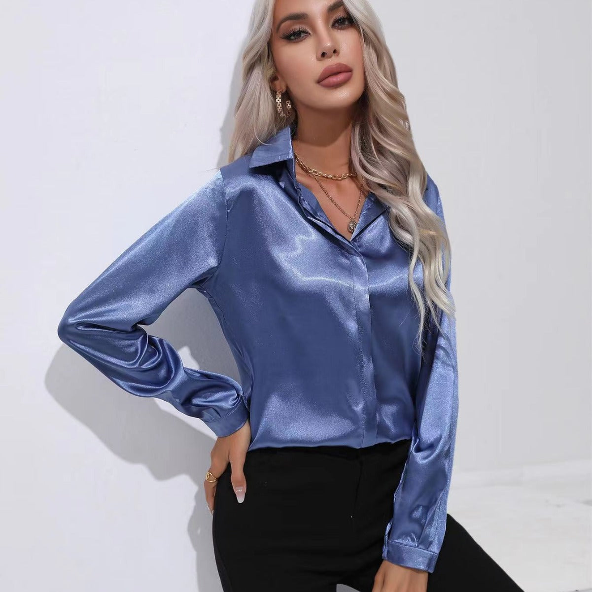 Blue satin button-up long-sleeve shirt with one-button placket and pointed collar.