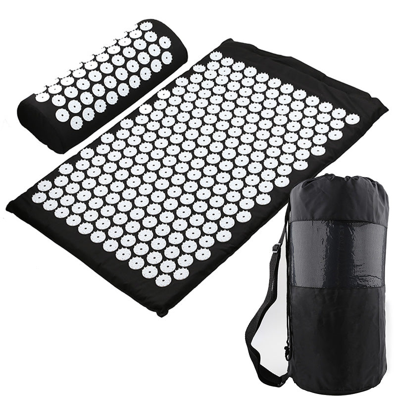 Black acupuncture yoga mat with spike clusters and matching rolled storage bag