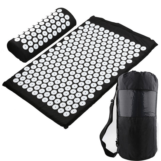 Black acupuncture yoga mat with spike clusters and matching rolled storage bag