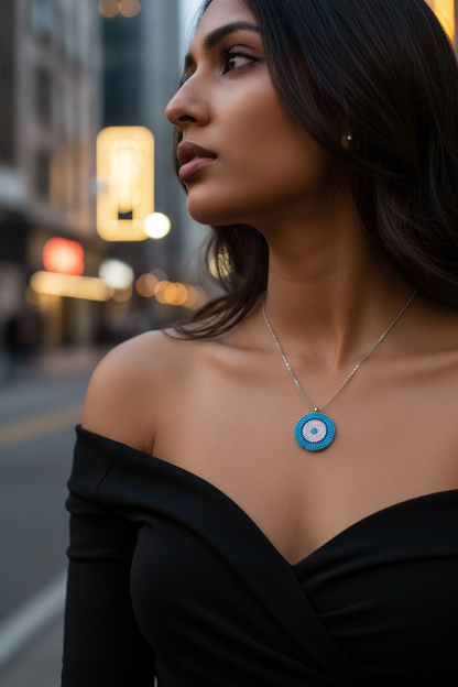 Turquoise beaded circular pendant necklace on sterling silver chain, side view