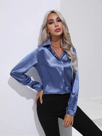 Blue satin button-up long-sleeve shirt with one-button placket and pointed collar.