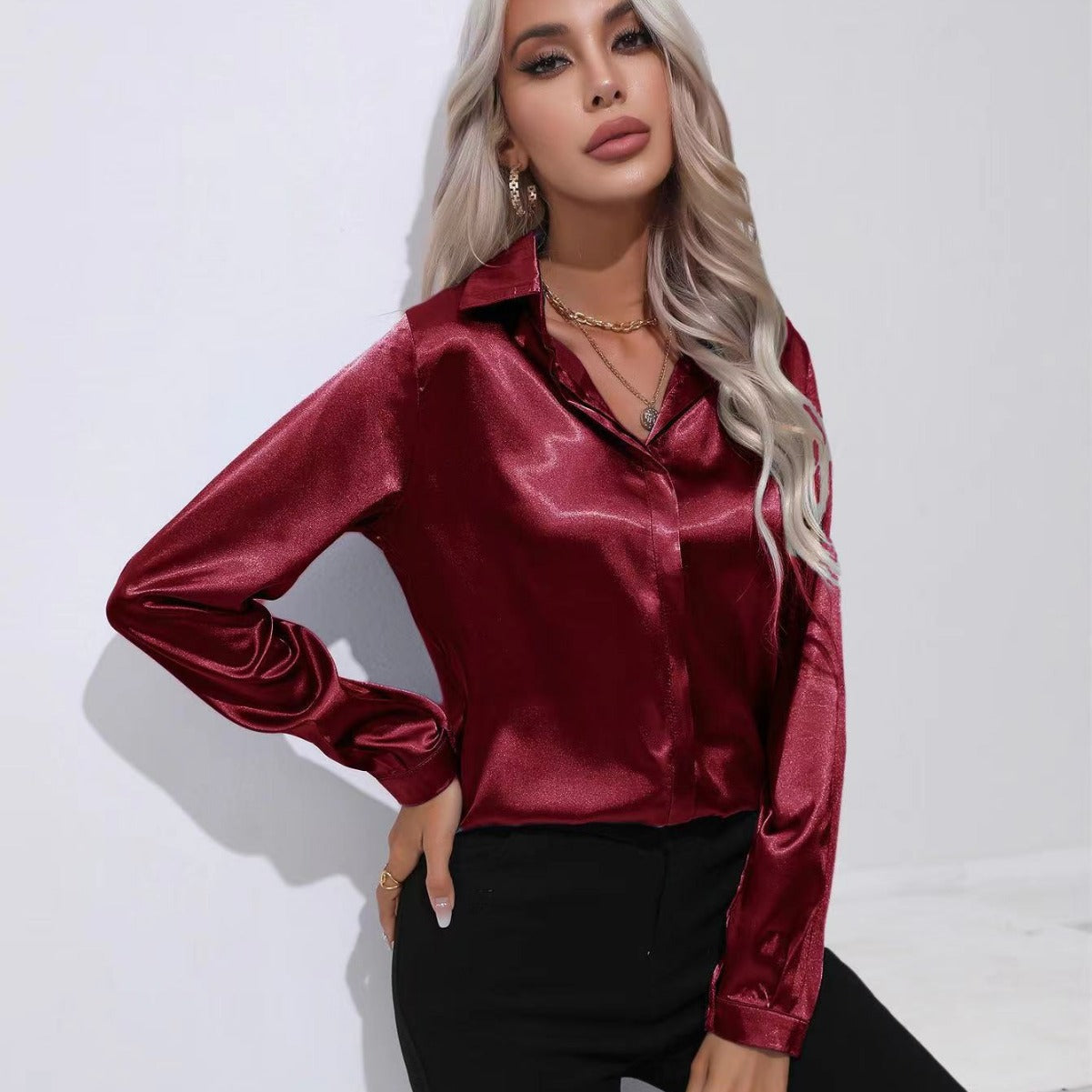 Red satin button-up long-sleeve shirt with one-button placket and pointed collar.