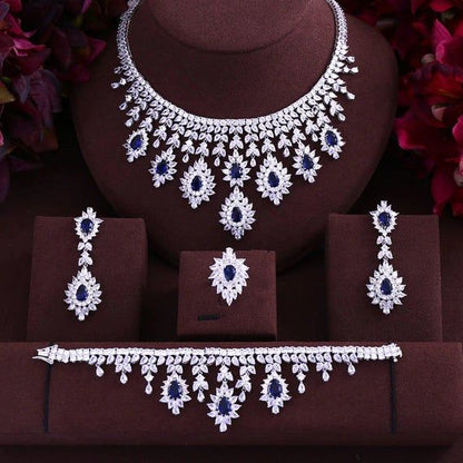 Silver-tone necklace and earring set with blue flower drop motifs and matching bracelet