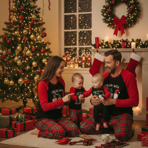 Holiday sleepwear jumpsuit with black body, red long sleeves, and red tartan plaid pants