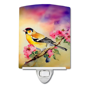 Ceramic night light with goldfinch and pink blossoms, attached to a wall plug base