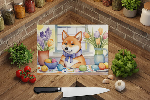 Glass cutting board with Shiba Inu Easter eggs and flowers, shown on a wooden surface