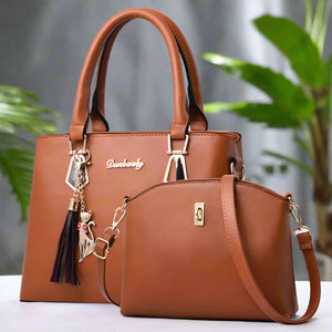 Brown PU handbag and crossbody bag set with top handles, shoulder strap, and charm details